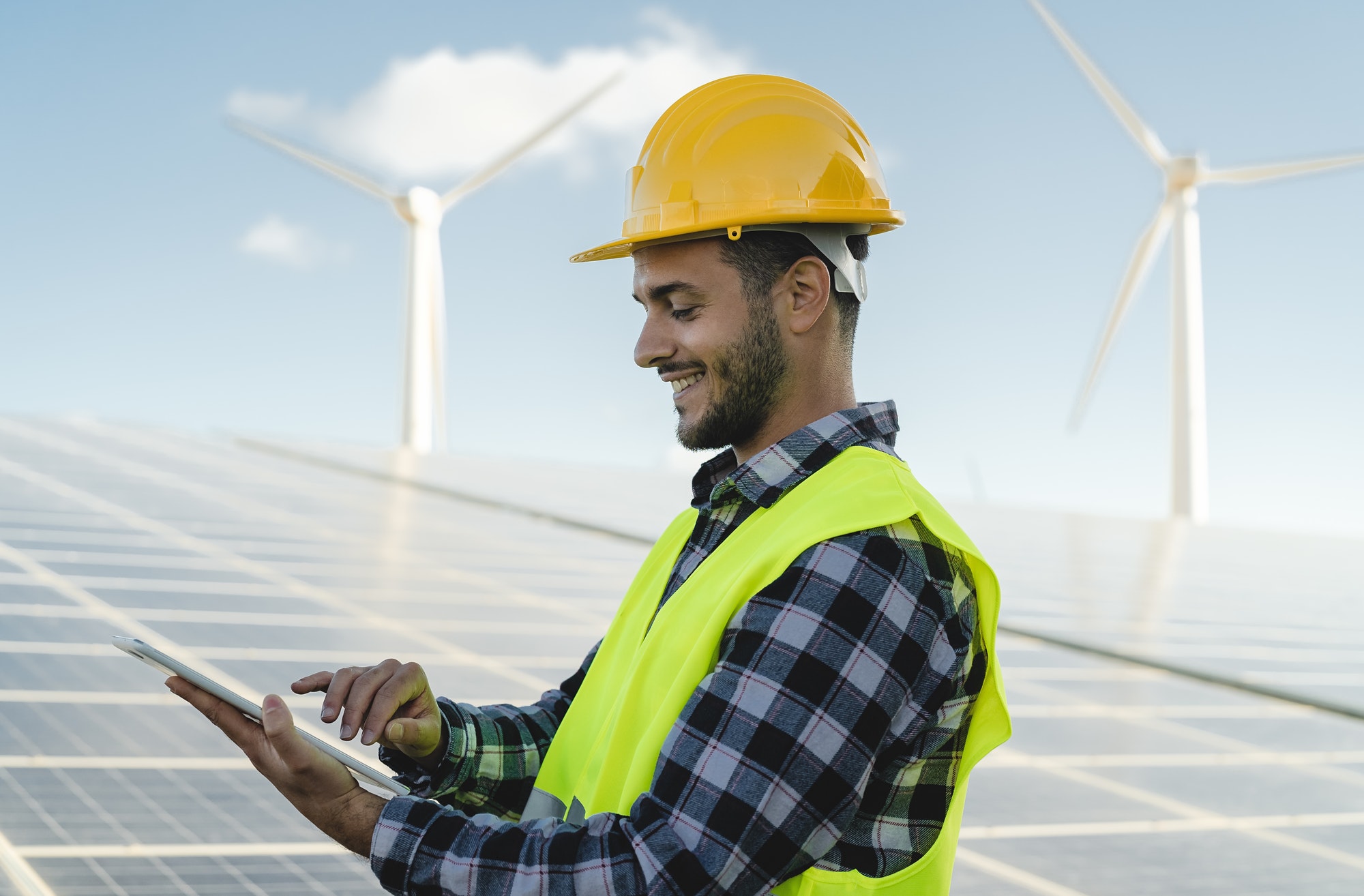 young-engineer-watching-on-tablet-the-green-plan-for-alternative-energy-with-turbine-and-solar-panel.jpg