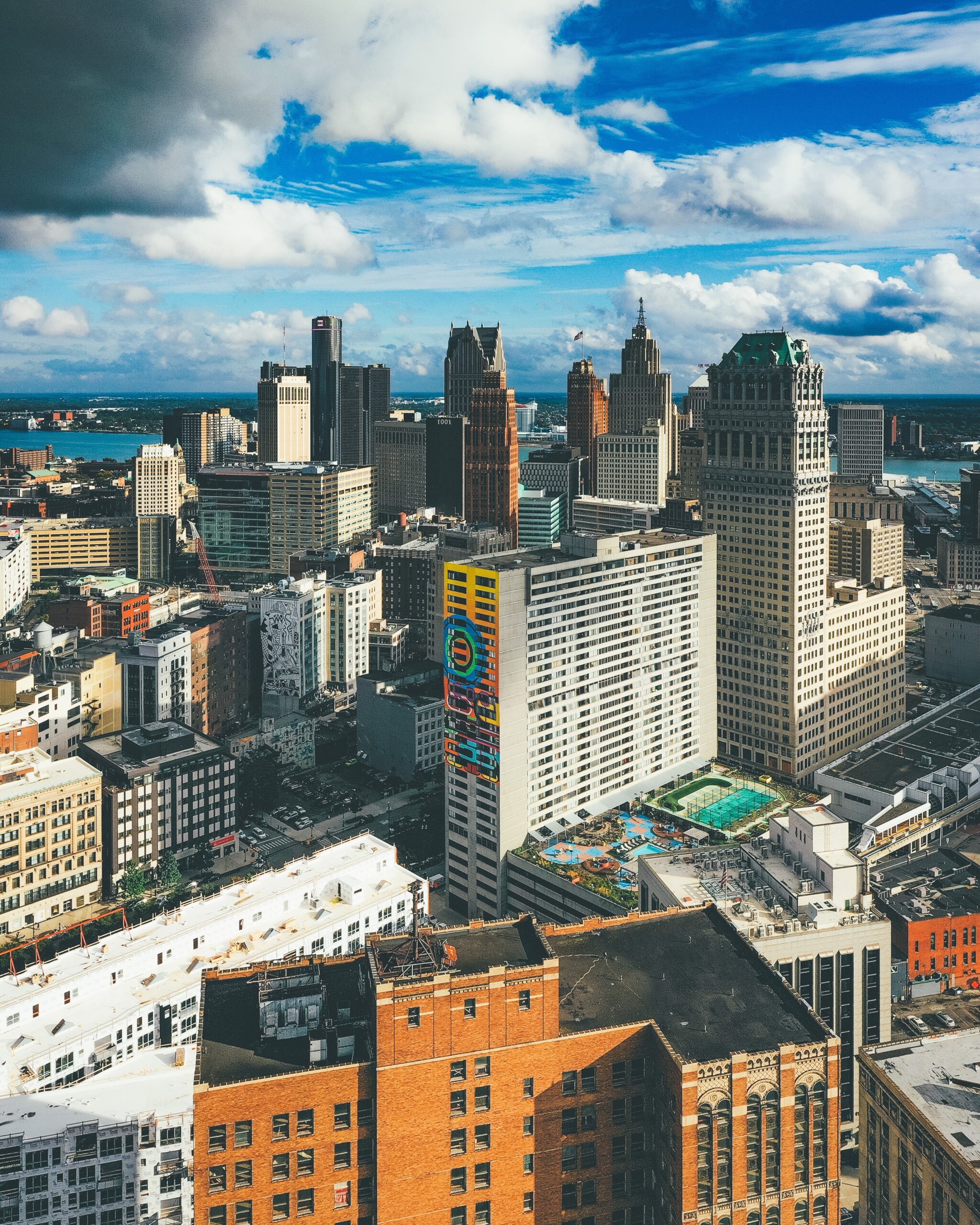 A vertical picture of buildings under a cloudy sky and sunlight in Detroit in Michigan, the USA